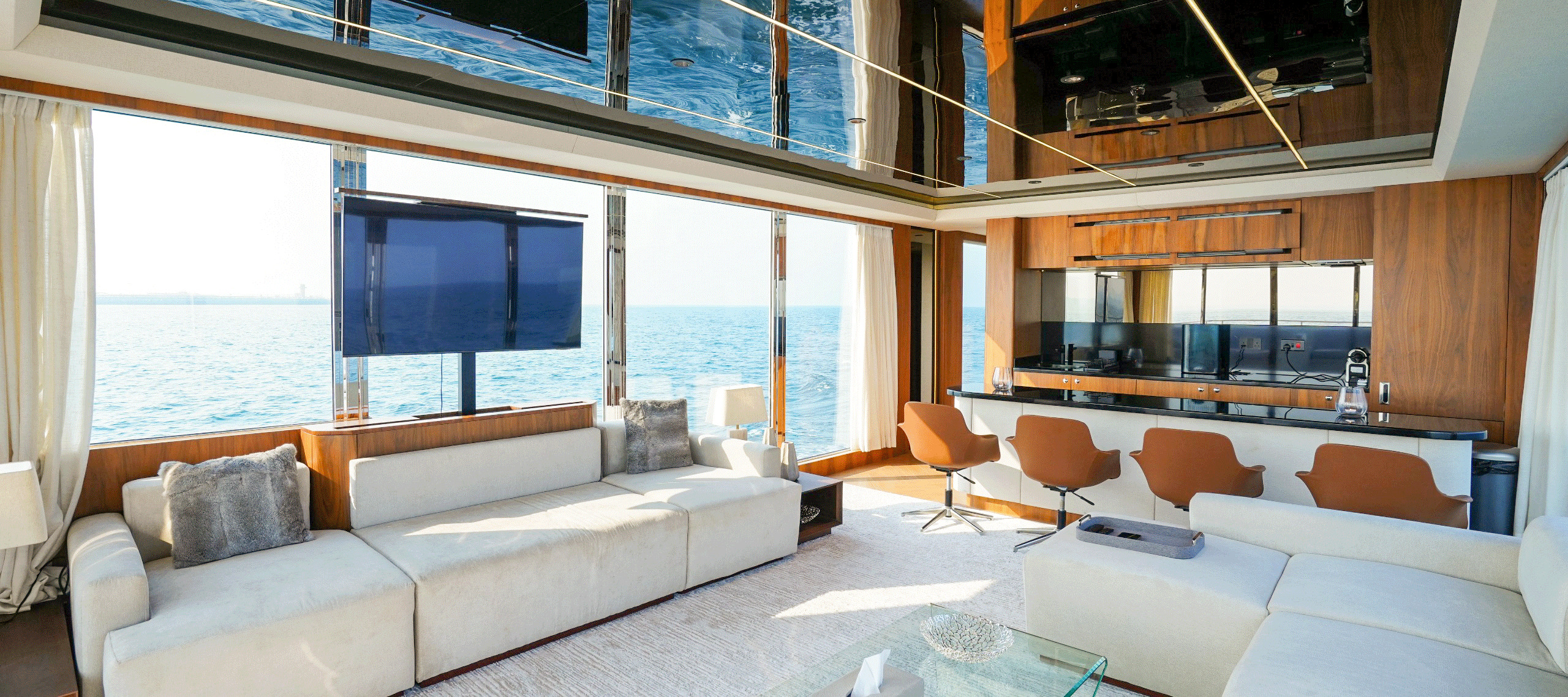 RISE 60 main saloon with cream sofas and panoramic windows onto the sea